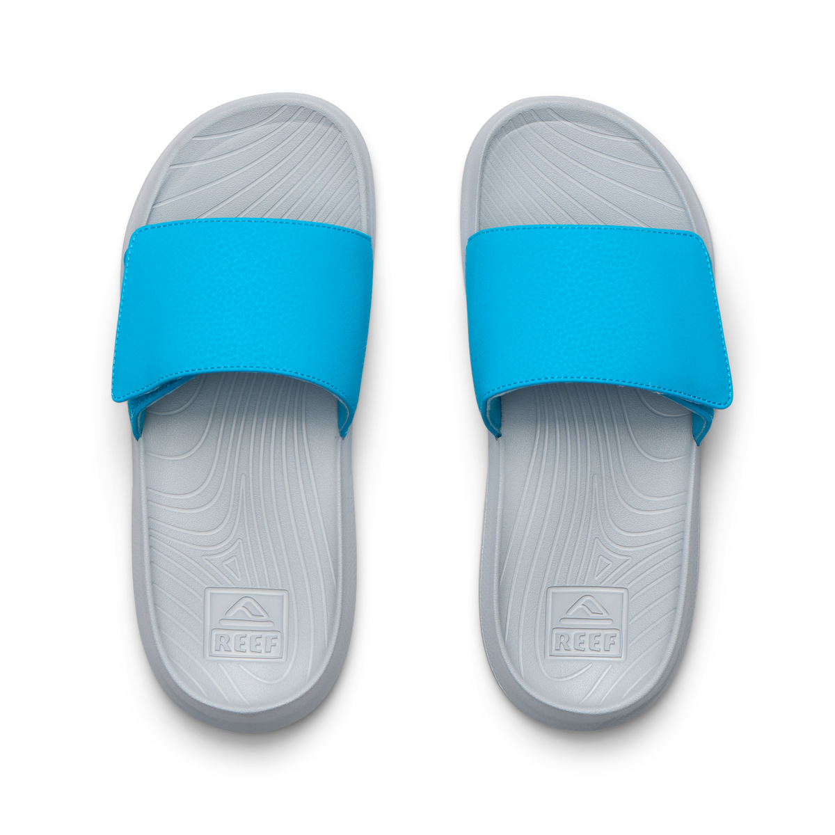 Top-down view of Kids Salty Slide in grey and blue facing upward, showing molded footbeds with arch support and cushioning.