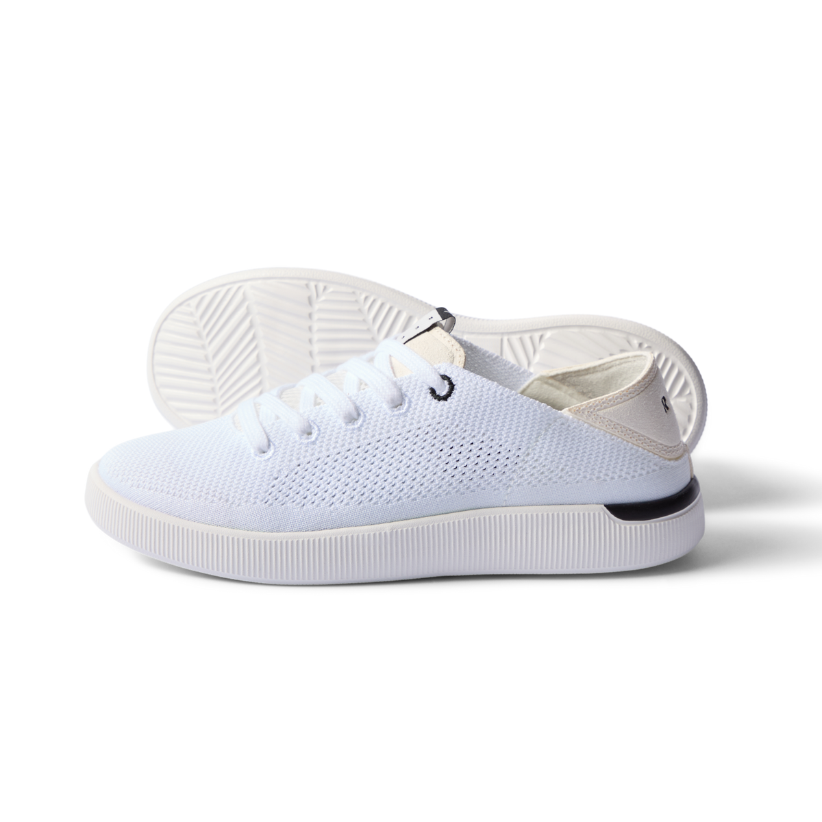 Reef Neptune women's white and black sneaker with breathable knit, anatomical arch support, and cushioned sole facing left side.