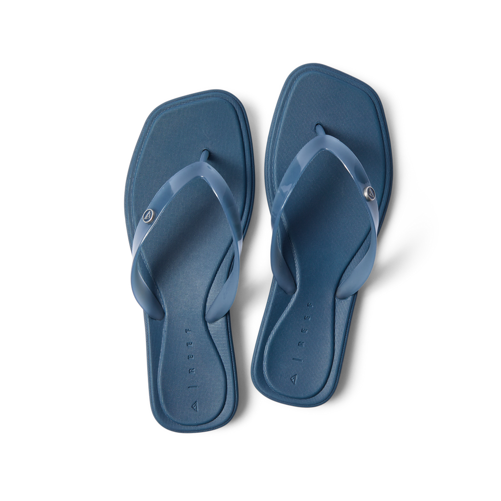 Solaye women's navy blue flip flops facing upward, featuring soft cushioning and anatomical arch support for beach comfort.