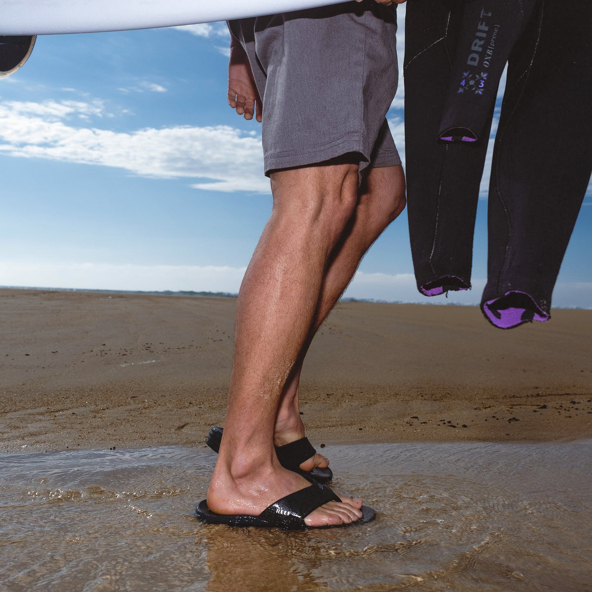 Fanning H2O facing right, men's black water-friendly sandals with anatomical arch support and cushioned footbed on wet sand
