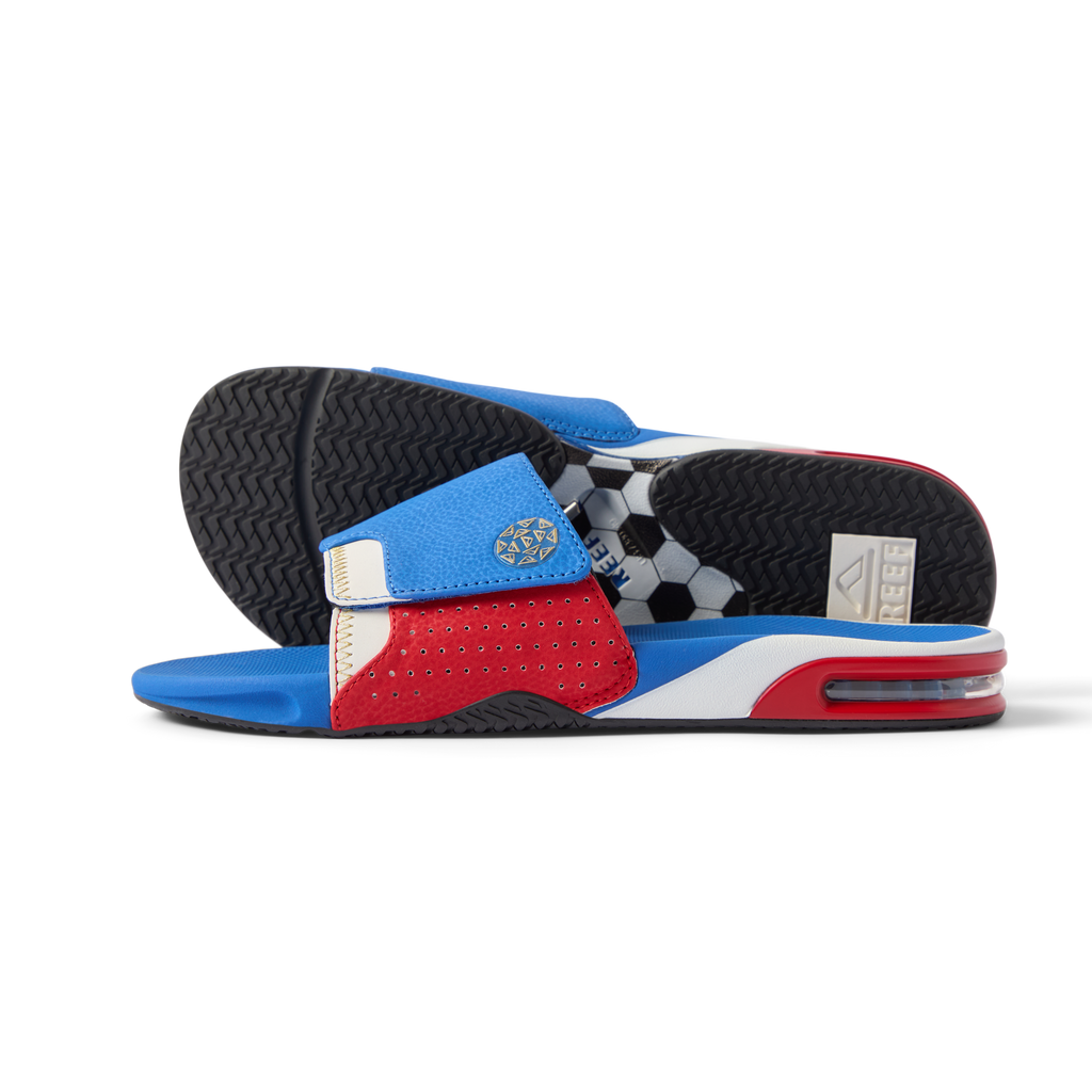 Pair of Fanning Slide sandals facing right with red, white, and blue water-friendly upper and cushioned EVA footbeds.
