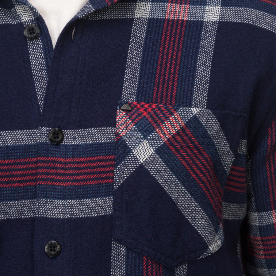 Close-up of the chest pocket and button placket on the navy and red Houston Flannel Shirt for men.