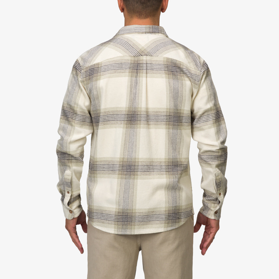 Back view of a man wearing a cream and gray Houston Flannel Shirt, showcasing the shirt’s relaxed fit and plaid pattern.