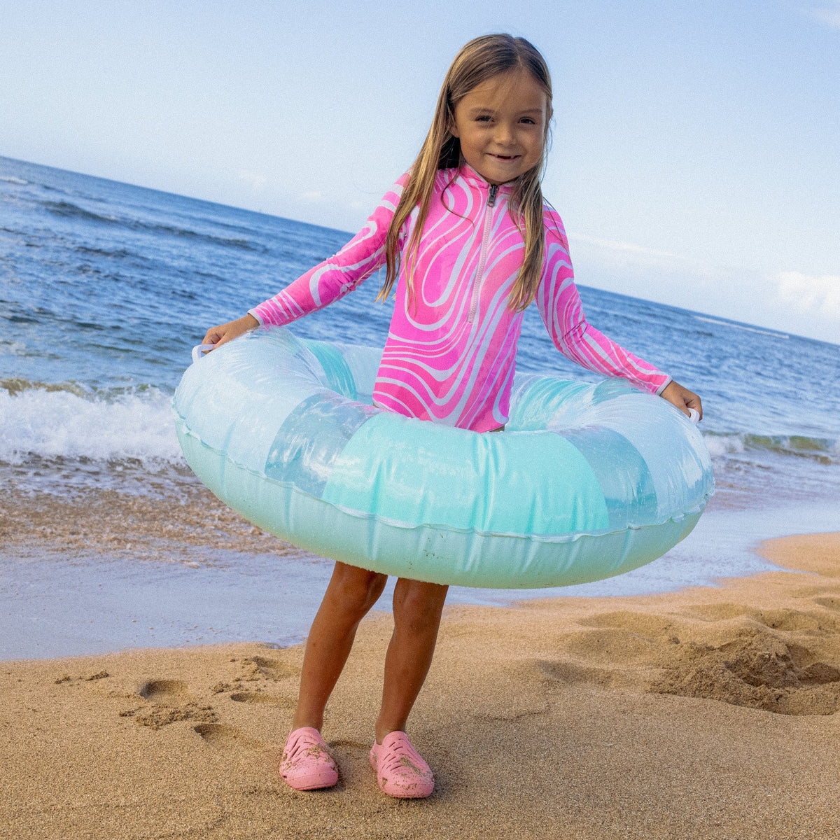 Kids Reef Sandbar shoes facing forward on a girl at the beach, featuring water-friendly, comfortable, durable design.