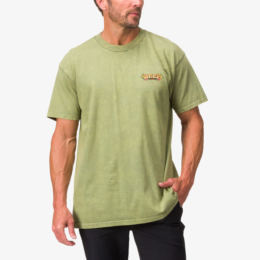 Man wearing a moss stone mineral wash Lonnie Tee with small Reef logo on chest, front view, casual fit and short sleeves