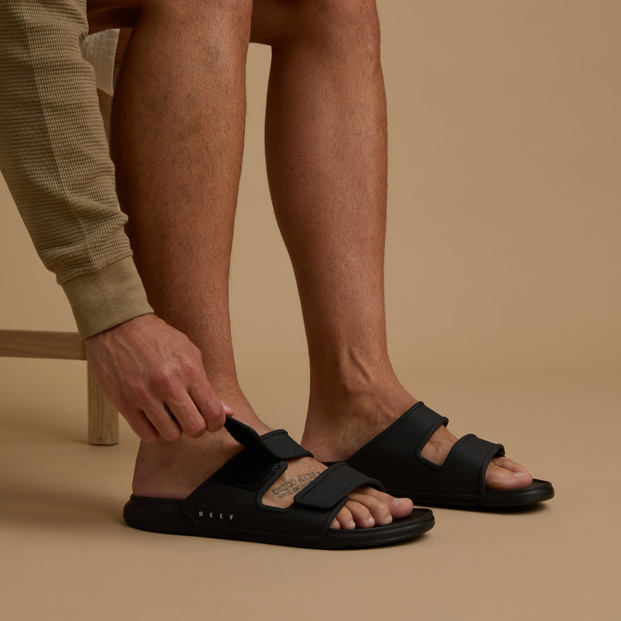 Oasis Adapt black men's sandals facing right, close-up of footbed and adjustable straps, comfort-focused design.