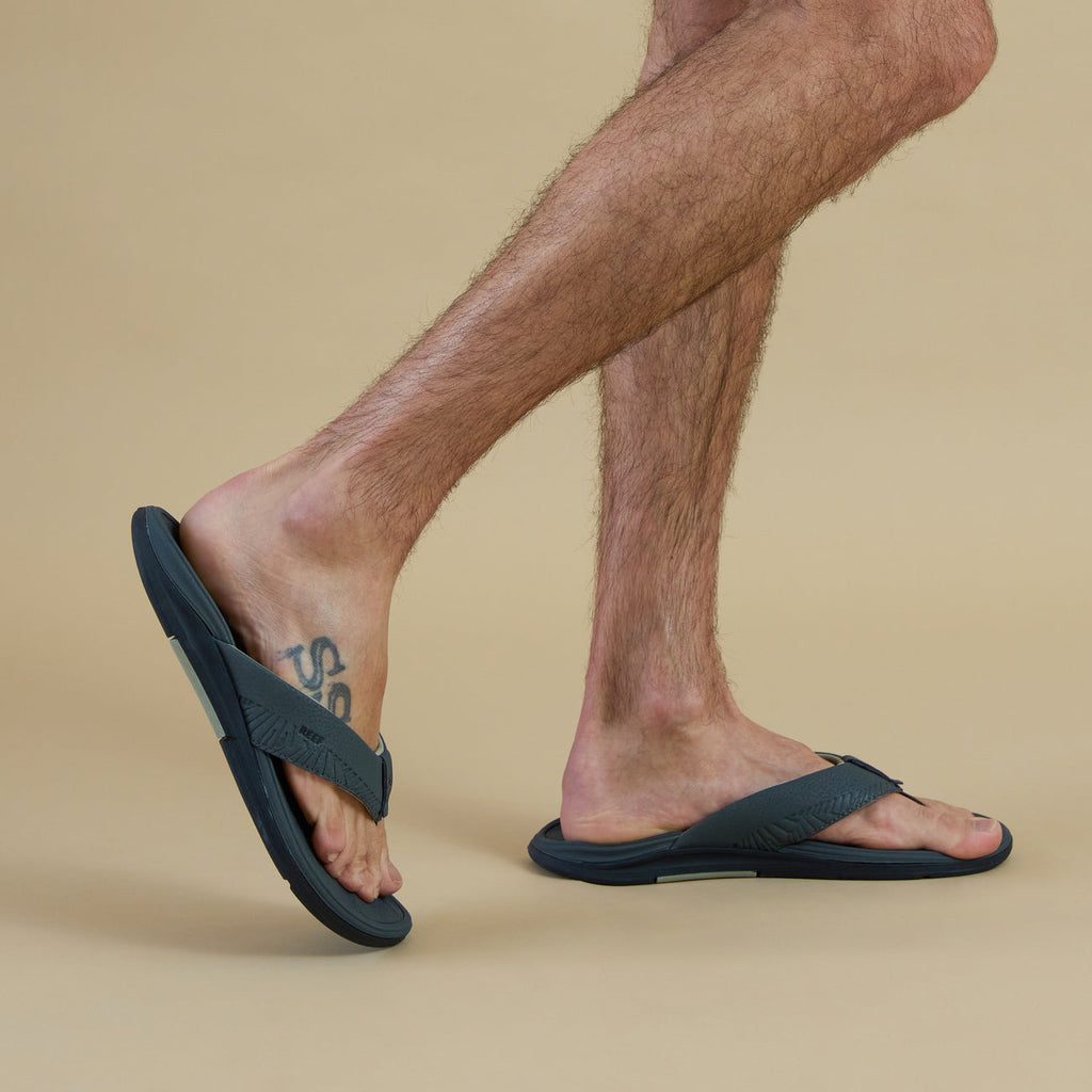 Offshore men's grey flip flops facing right on foot, showing side and top views with cushioned arch support.