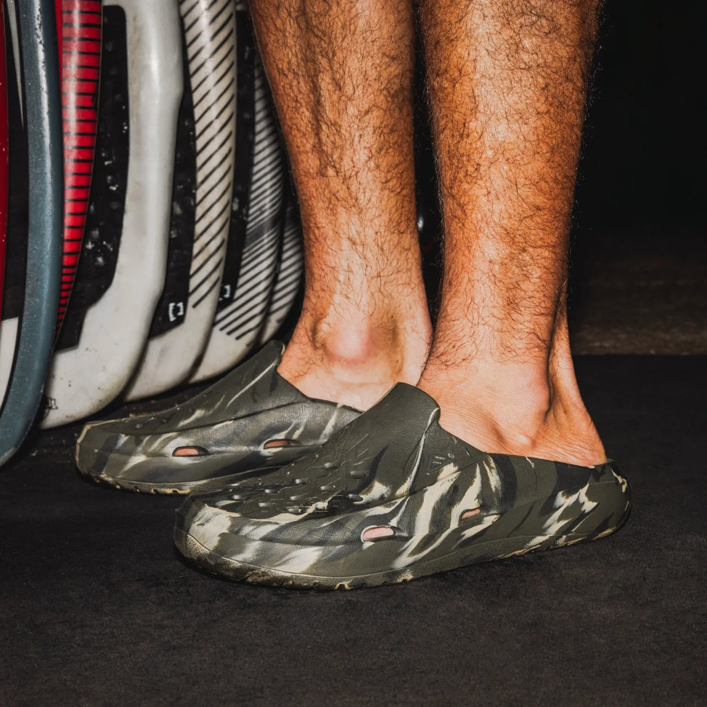 Glider shoes in green camo facing right, close-up of back and side showing lightweight, water-friendly design.