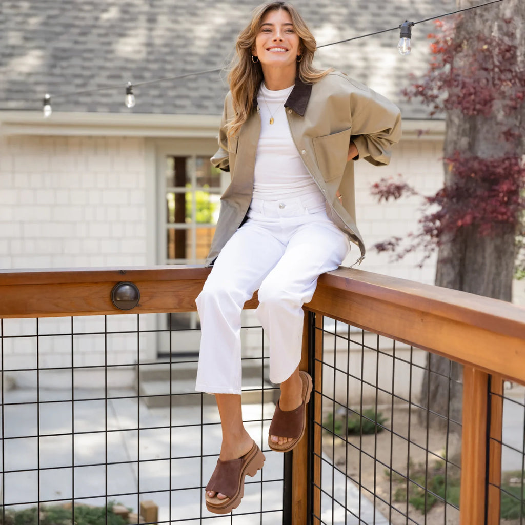 Woman wearing brown Vista Luxe Evie sandals facing left, showing side view with soft cushioning and arch support.