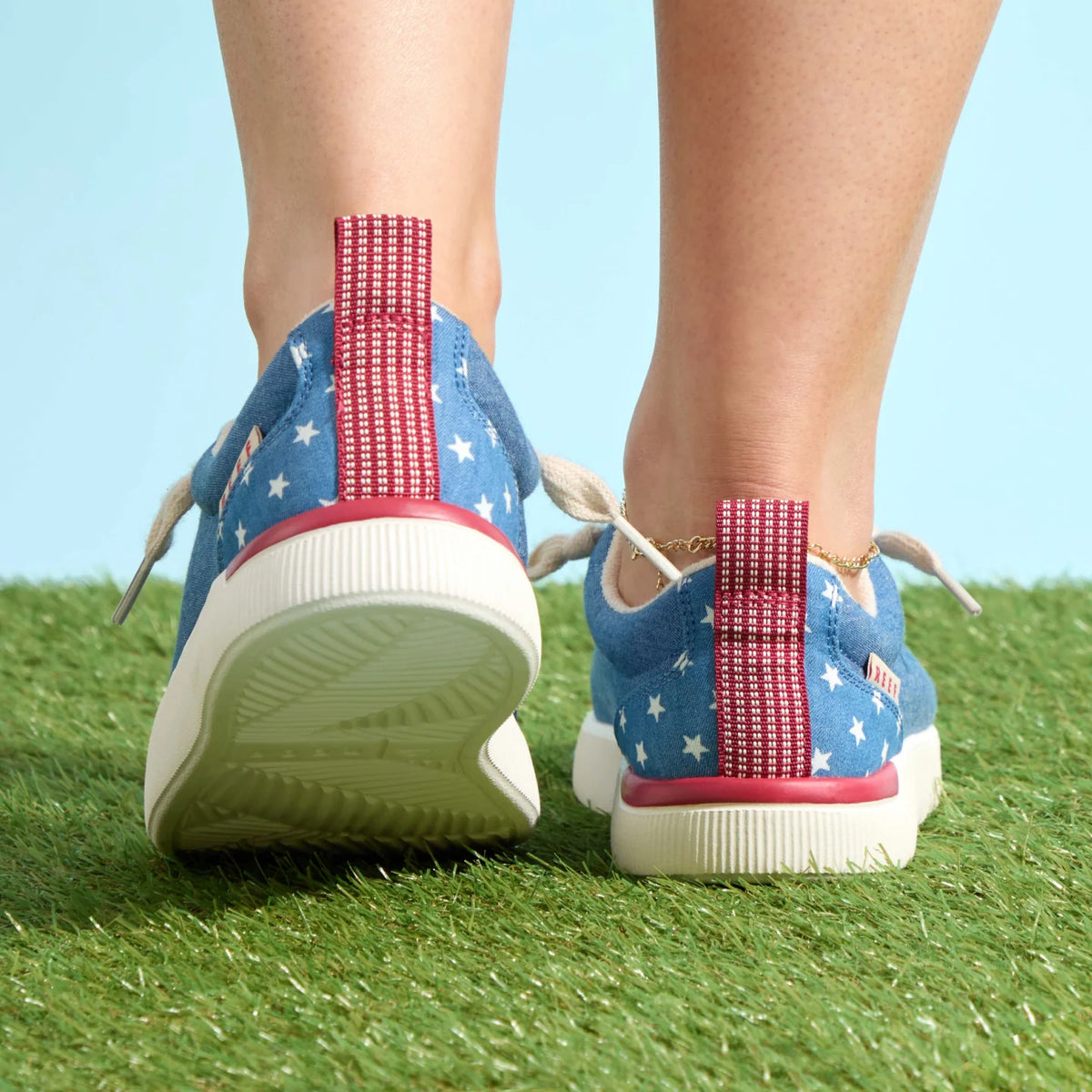 Pair of Neptune Alana sneakers facing backward, showing heel and red pull tab, surf-inspired comfort and durable design.