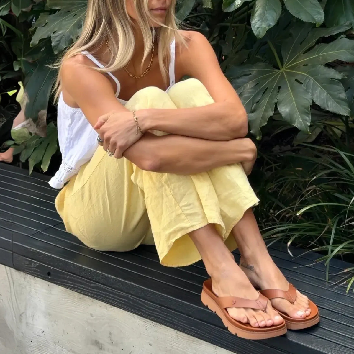 Vista Luxe Vivianahh sandals facing forward, close-up of tan water-friendly flip flops with arch support on woman’s feet