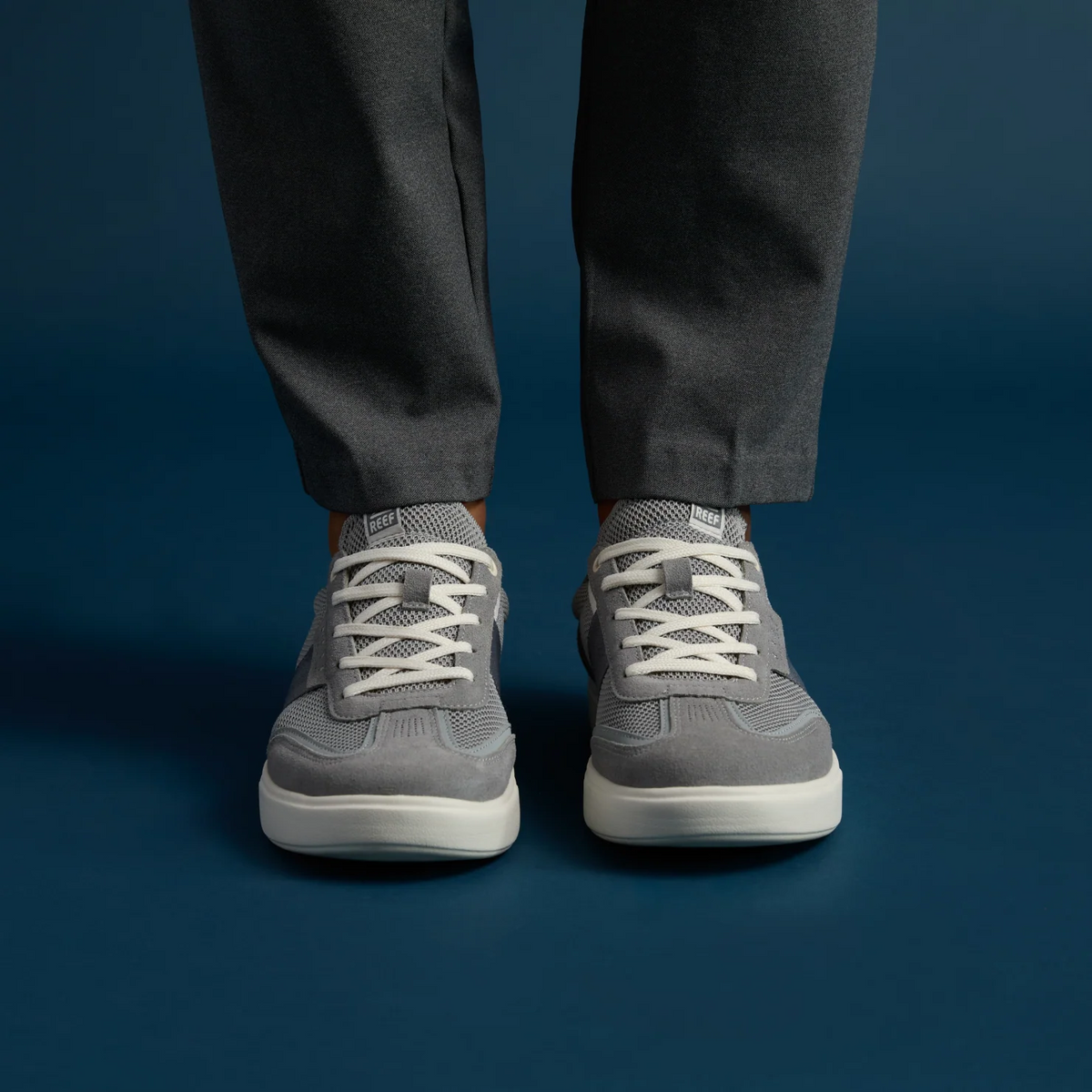 Triton men's grey sneakers facing forward, showing cushioned, breathable upper with lace closure, beach-inspired comfort design.