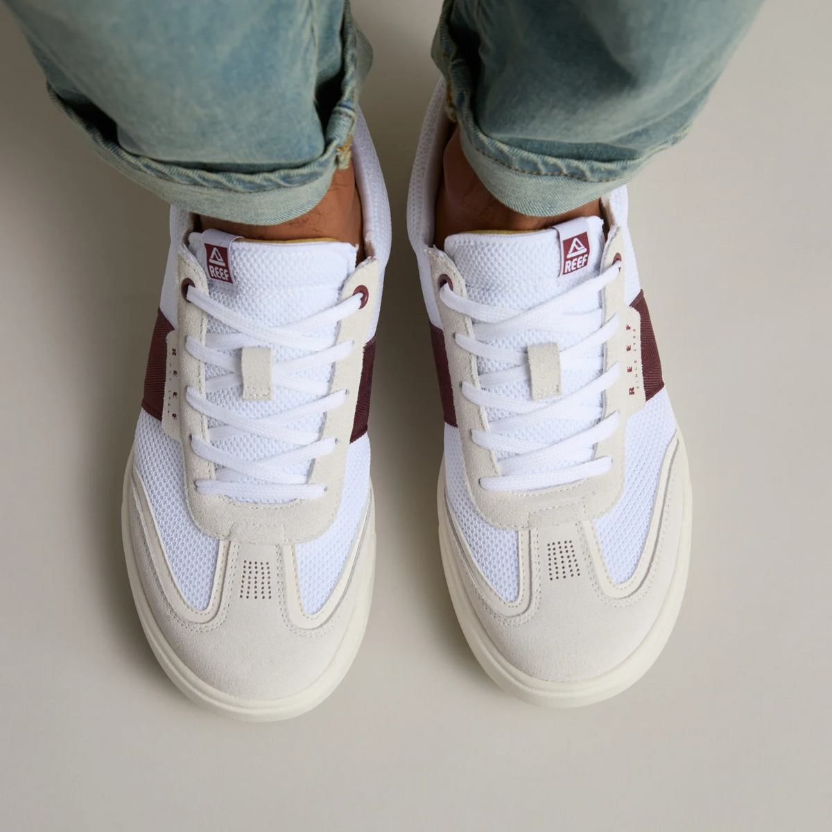 Top view of men's Triton sneakers in white with burgundy accents, featuring breathable mesh and cushioned comfort.