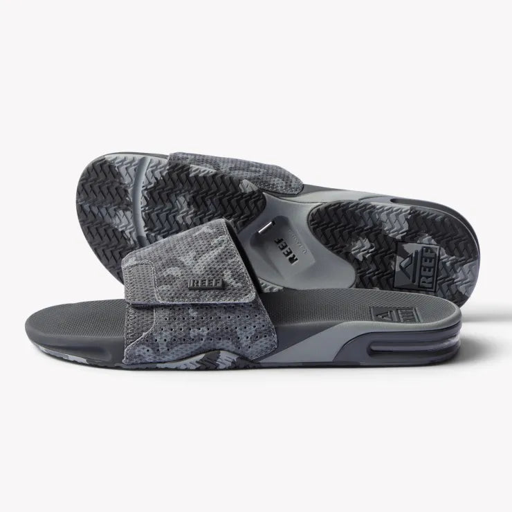 Pair of gray camo Fanning Slide sandals facing right showing top and sole, featuring arch support and bottle-opener style