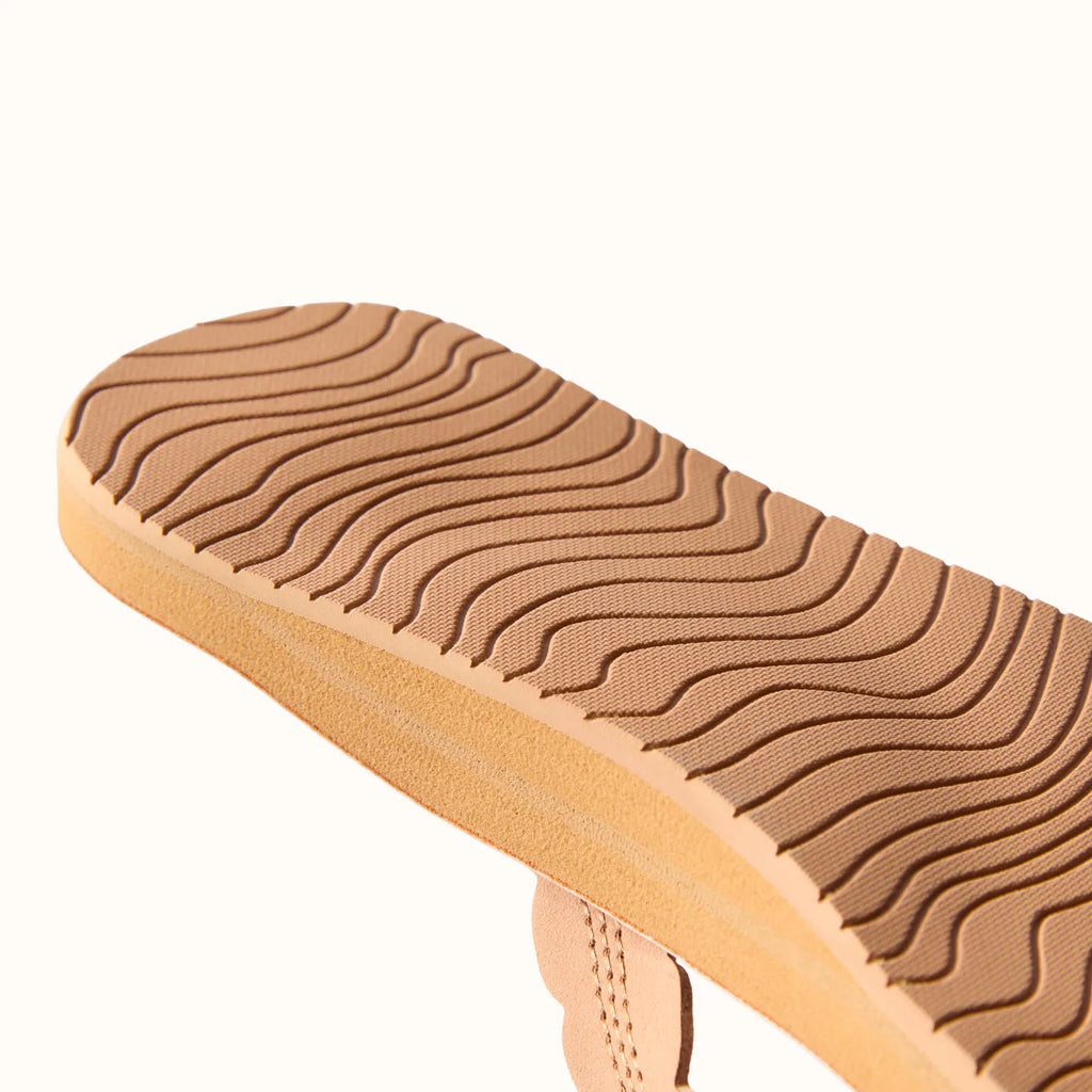 Reef Celine x Jenny close-up of tan sandal sole facing up showing textured tread for durability and beach-ready comfort
