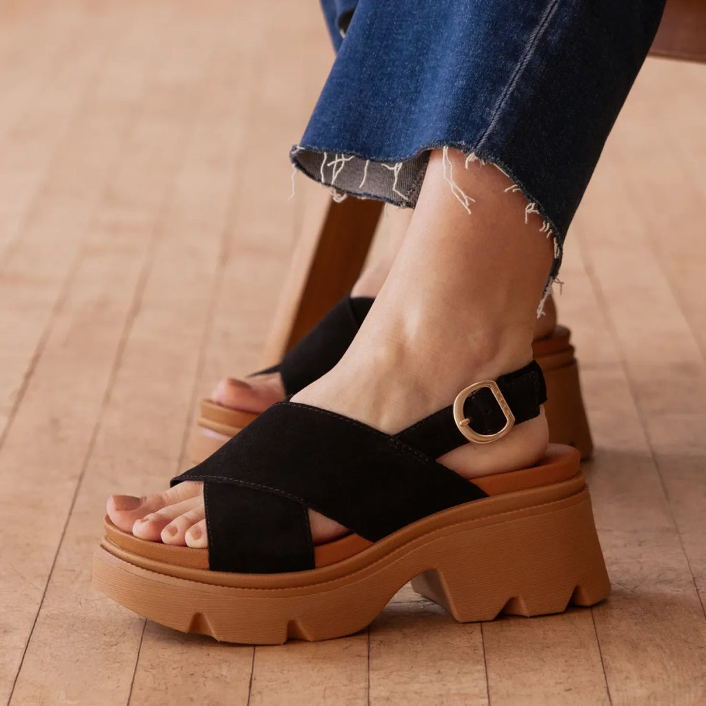 Vista Luxe Ava black suede platform sandal facing left in close up, with crossover straps and an adjustable buckle