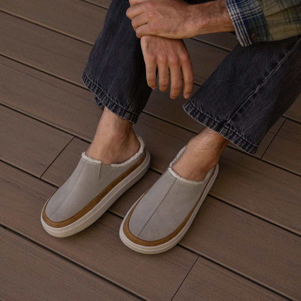 man wearing Rambler Mule Brown and sitting outside a cabin