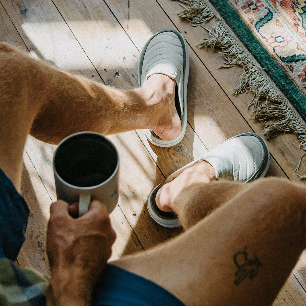 Rambler Kicker gray mules facing upward, worn indoors for cushioned everyday comfort