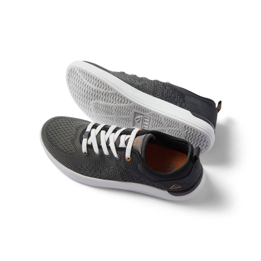 Pair of black and white Neso men's sneakers featuring anatomical arch support, soft cushioning, and rubber outsole, right shoe facing left.