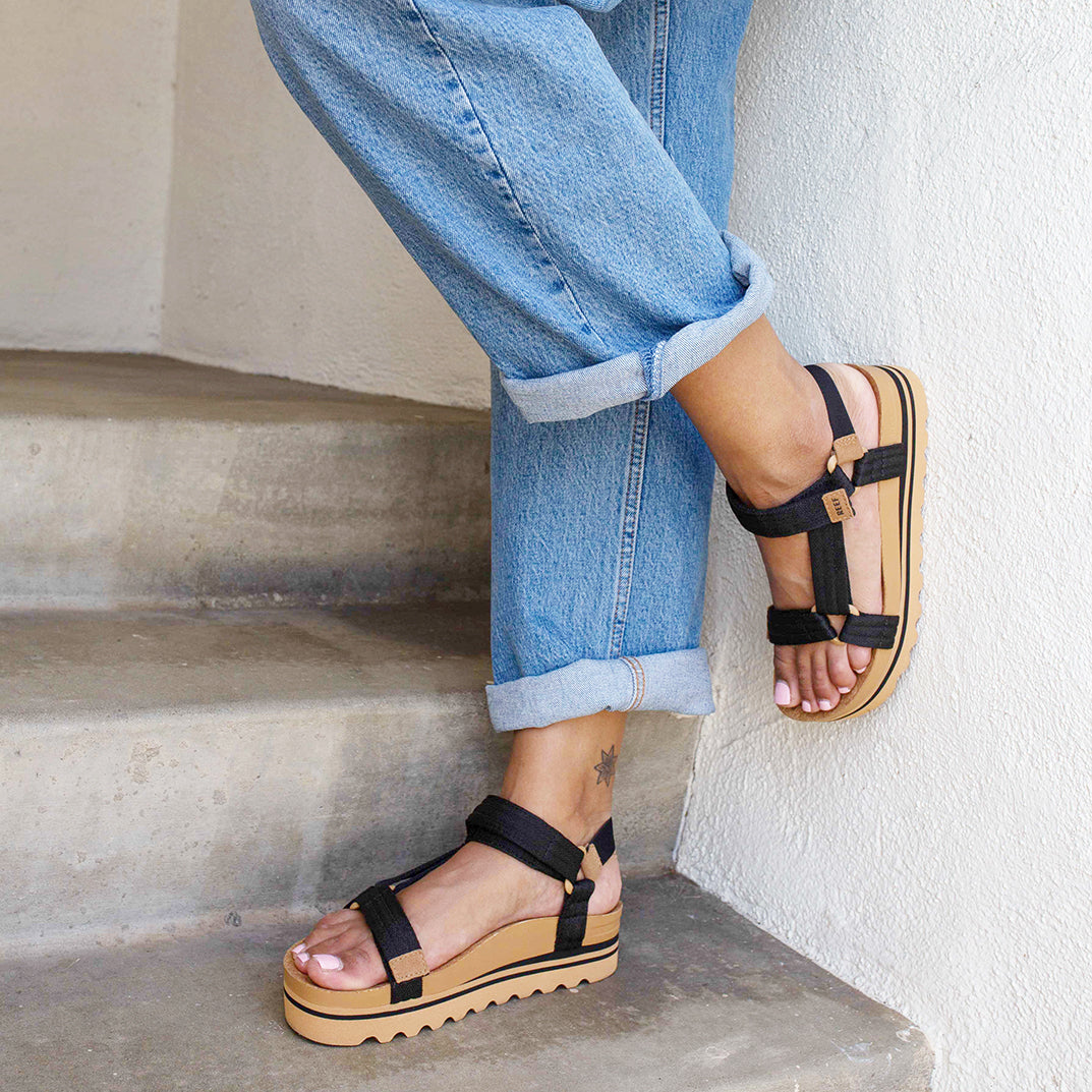 woman in stairwell wearing corkbed platform sandals in the sun